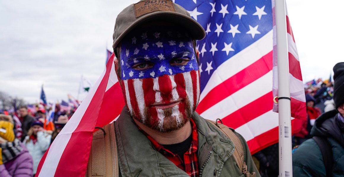 Capital Hill Protestor with American flag painted on his face.