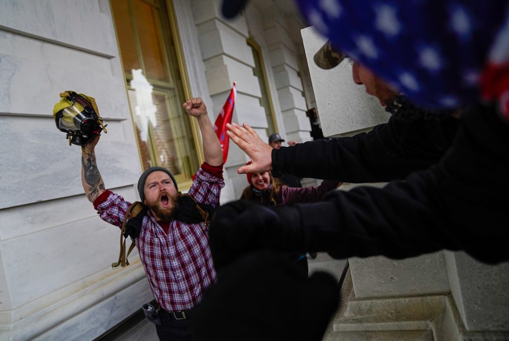 Capitol Hill protestor cheers with fists in the air